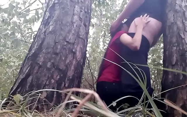 Frenzied lovers lick and fuck under the rain-soaked tree in the forest heat