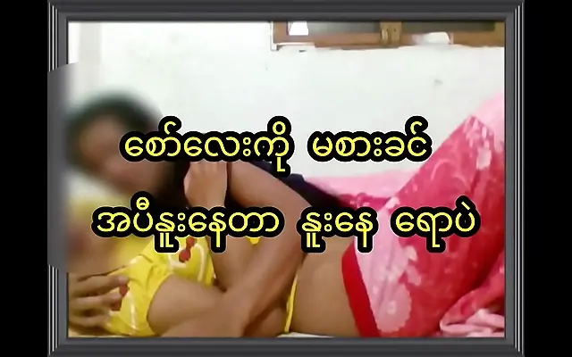 Wooden bed framed by sheer curtains young Asian couple enjoy passionate 69