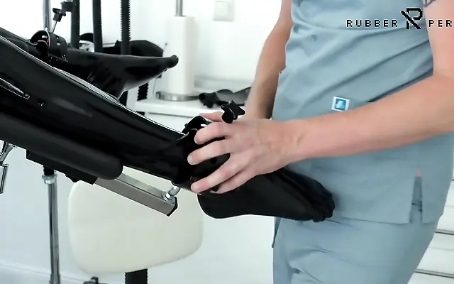 On all fours she takes the fuck machine while bound in shiny latex