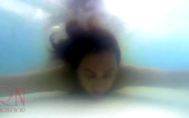 Poolside seductress Regina Noir teases and fucks in the shimmering water