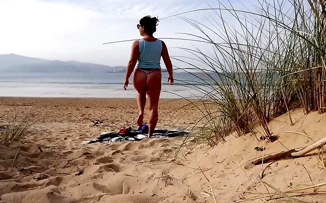 Through the window she teases with a curvy strip and beach workout show